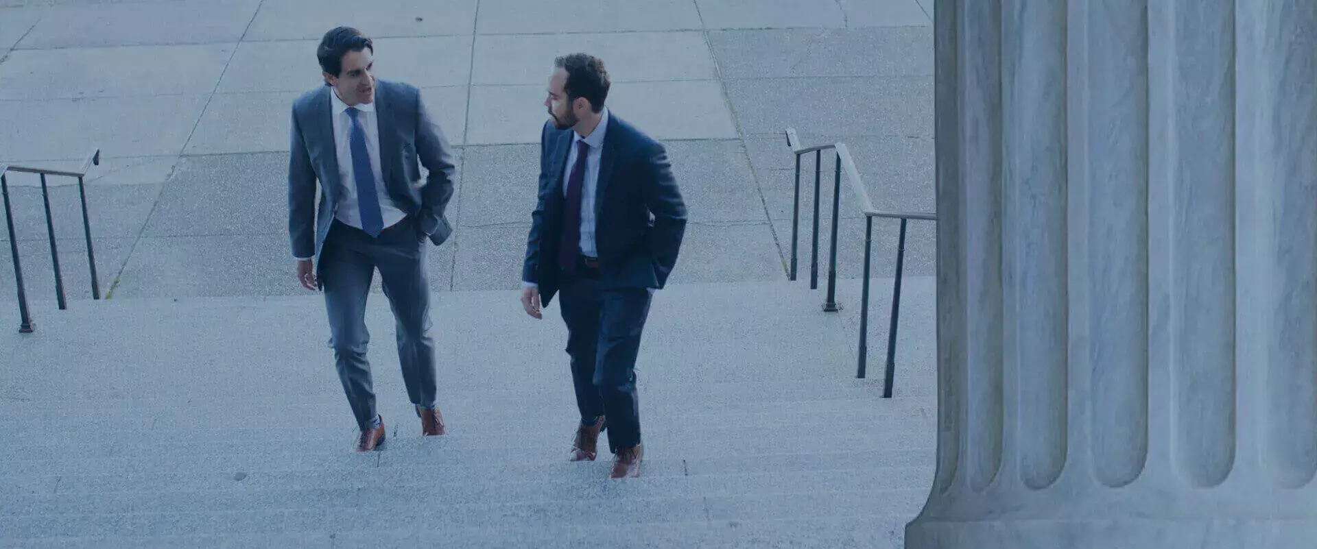 Two lawyers walking in the stairs