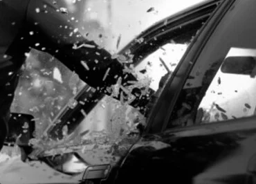 A man punch a car window
